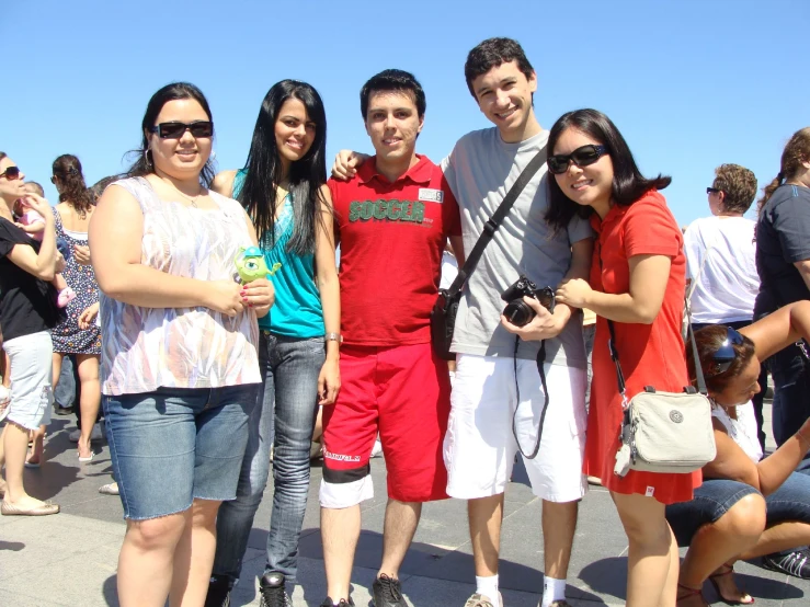 four friends taking a po and smiling at the camera