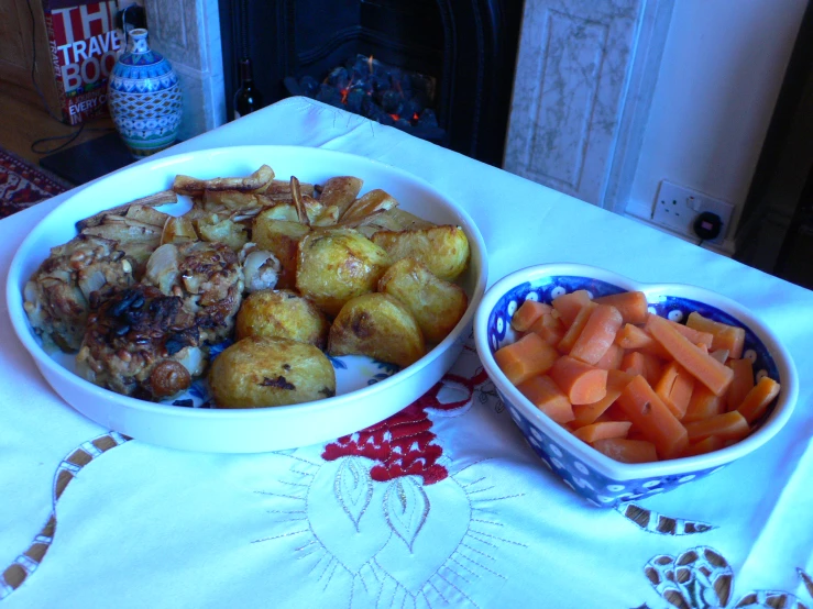 a bowl of potatoes and carrots are served