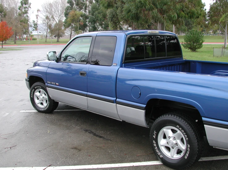 a blue truck parked in a parking lot
