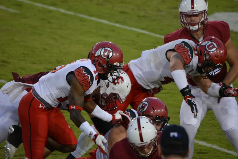 several athletes are seen preparing for a football game