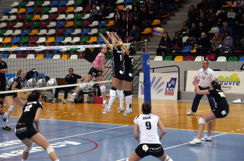a female volleyball player attempts to hit the ball