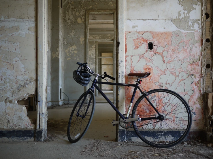 there is a black bicycle in the middle of a room