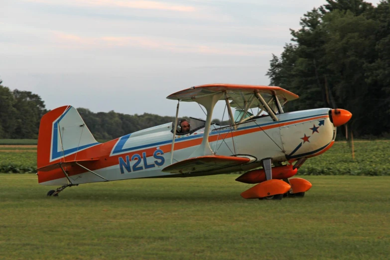 a small blue and white plane on a field