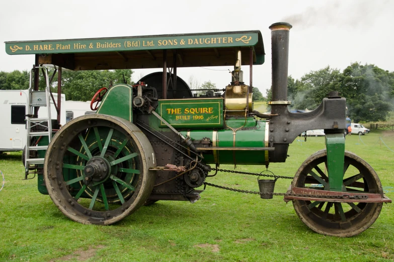 old fashioned engine train sitting in grass at a farm