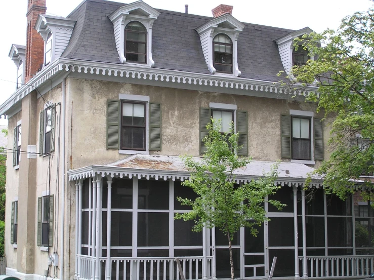 an old building has two story with a porch and windows