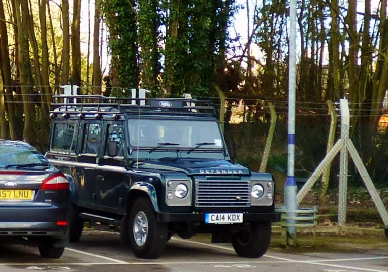 a big car parked in the middle of a parking lot