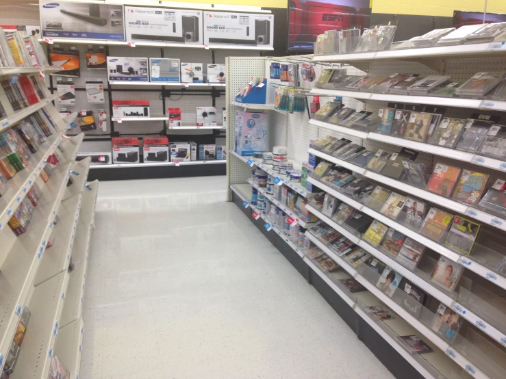 an aisle with aisles of magazines, dvds, and other items