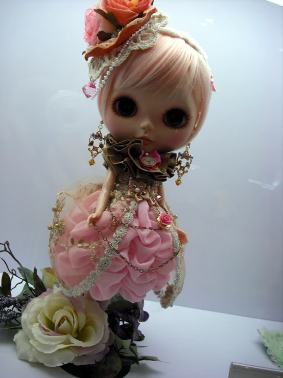 the doll is dressed in pink and gold