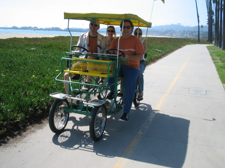 a couple of people riding on the back of a bike