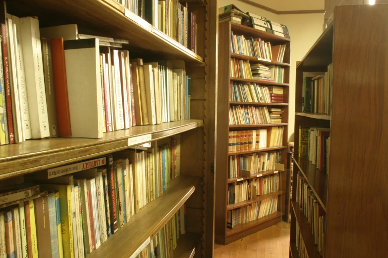 a bookshelf filled with many different colored books