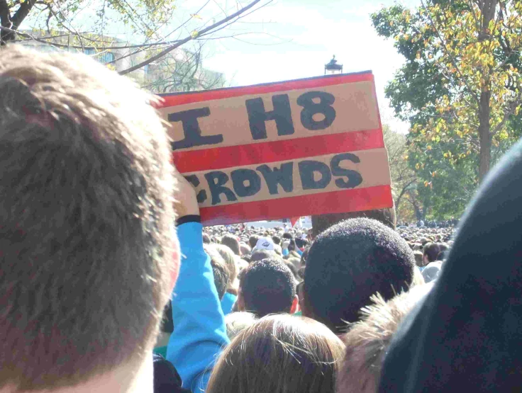 people holding signs that read, h8 rwrds
