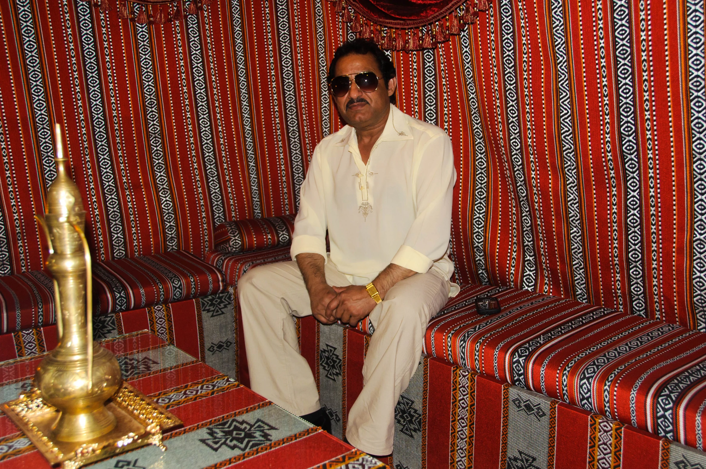 a man sitting on a couch with pillows