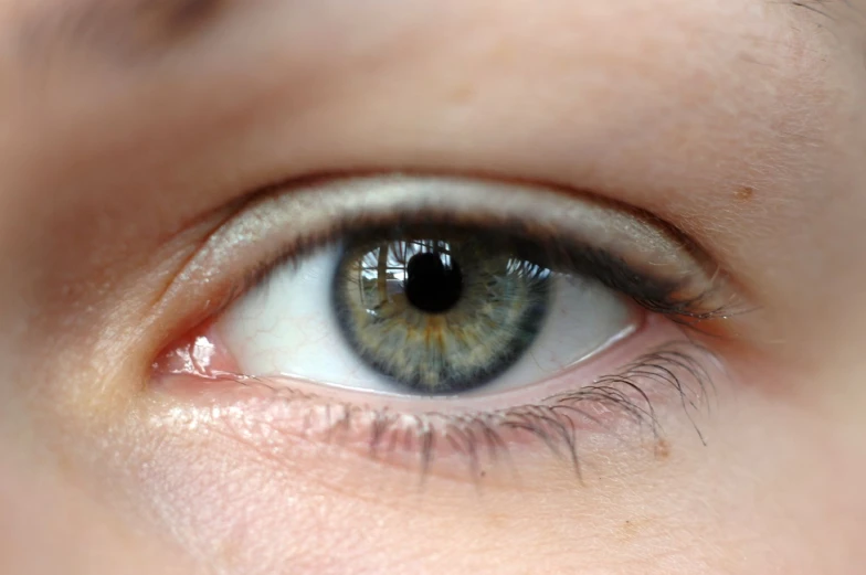 a close up of a young woman's blue eyes