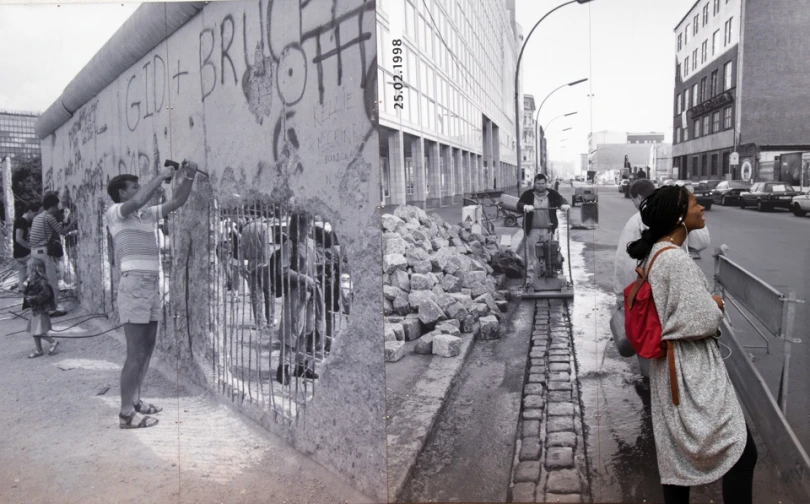 an old po of people standing by a wall