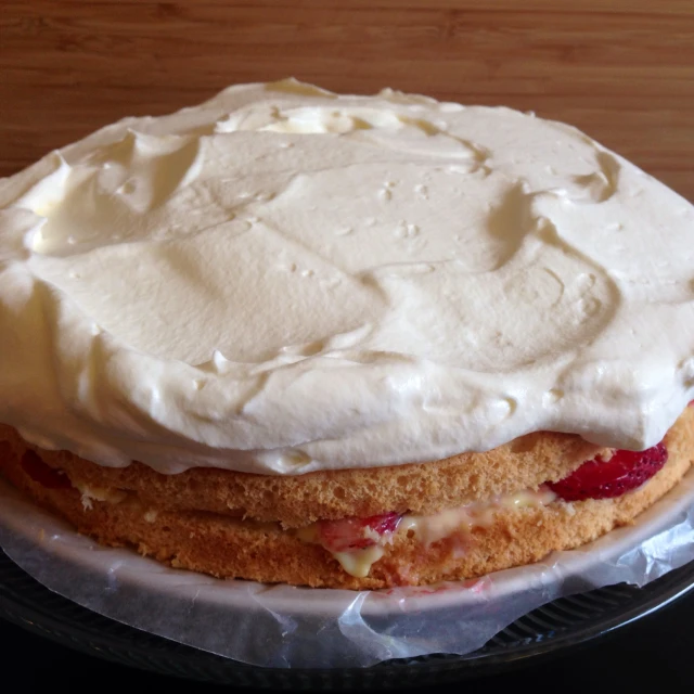 a cake with white icing and jelly on top