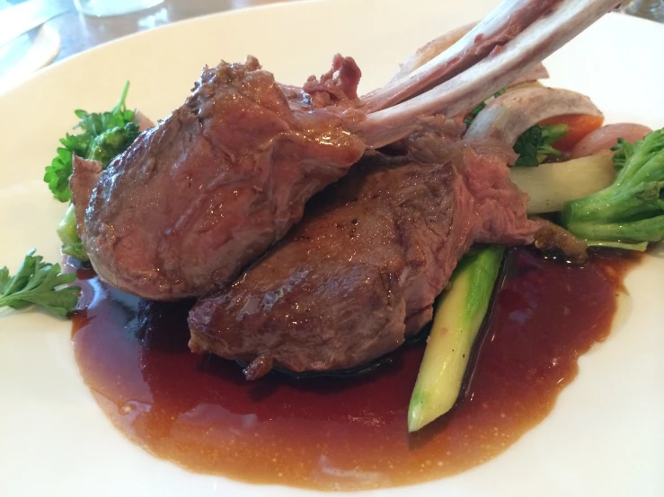 meat, broccoli, and carrots sitting on a plate