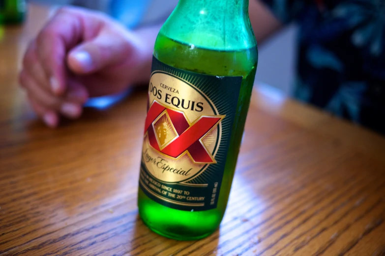 a bottle of beer with a logo is sitting on the table