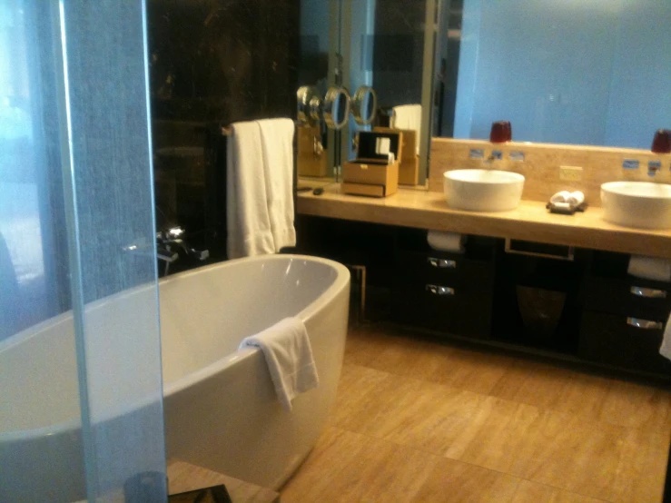 a bathroom with double sinks and a tub