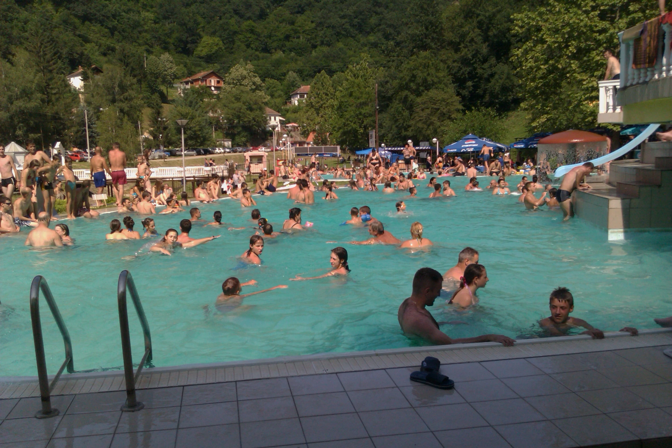 people swimming in a large open pool outside