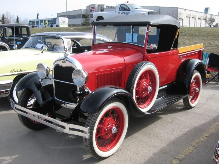 antique cars parked in a line on the street