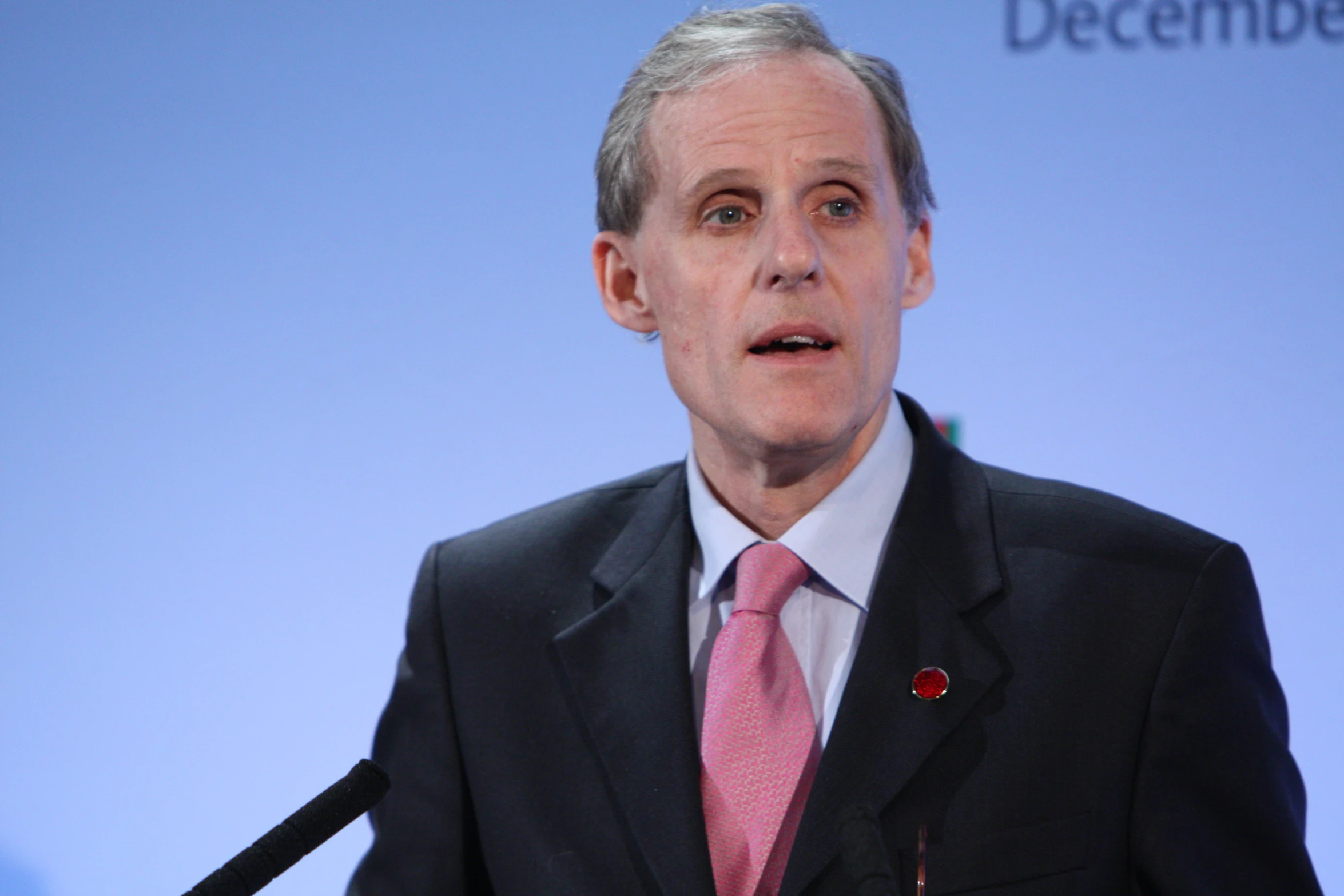 a man in a suit talking on stage