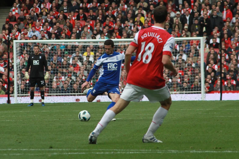 there is an image of two men playing soccer