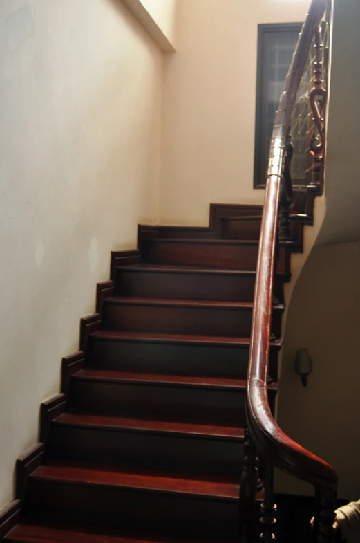 a set of wooden steps with wood rails and handrails