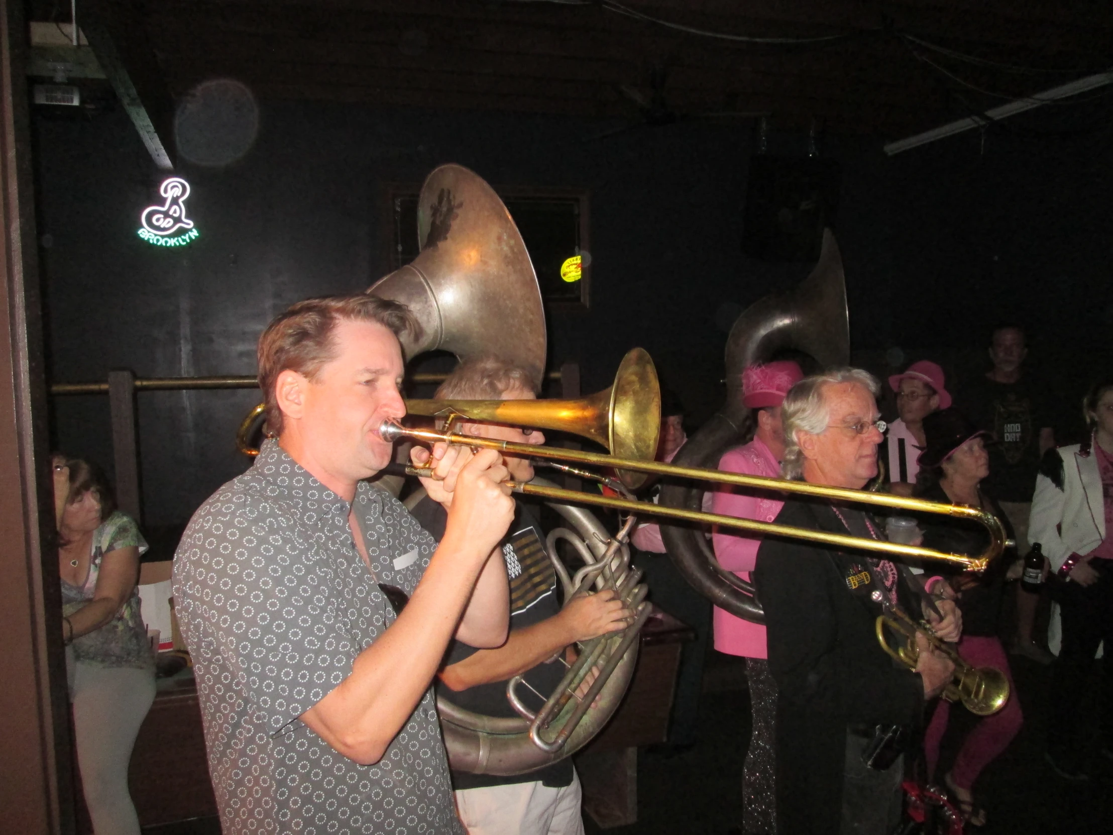 a man playing a trumpet in a crowd