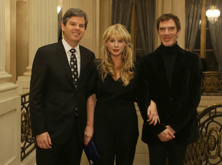 three people standing in an old - fashioned building