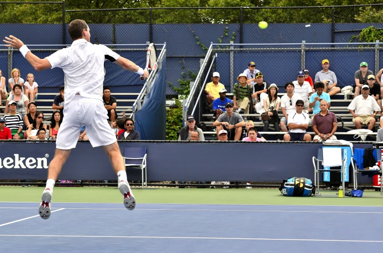 a male tennis player in the middle of a serve