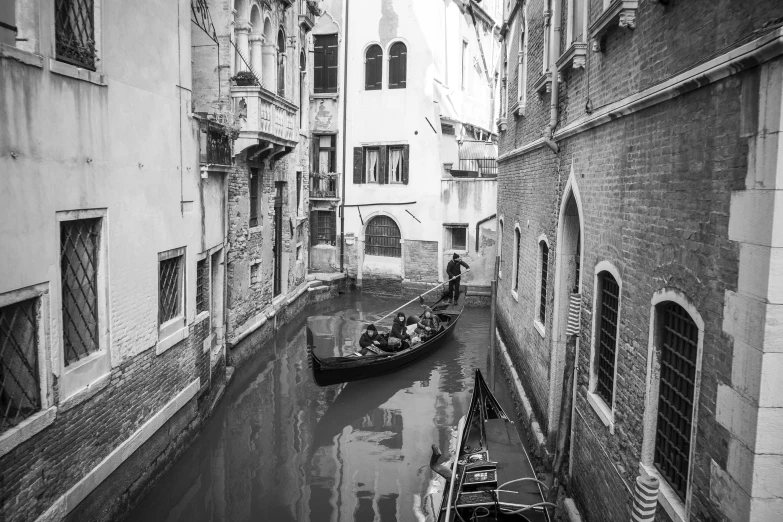 two gondolas on the water and an old building next to them