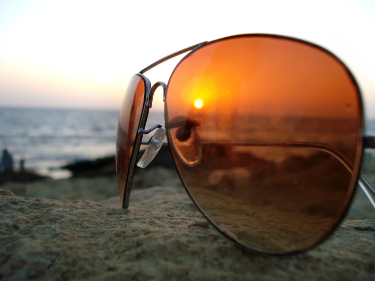 a reflection in some sunglasses with the sunset reflected on it