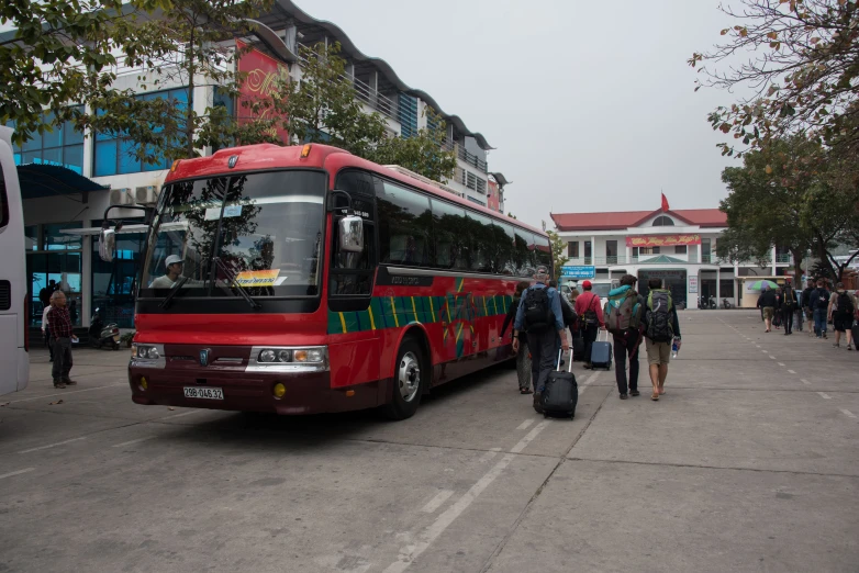 a big red bus is on the street