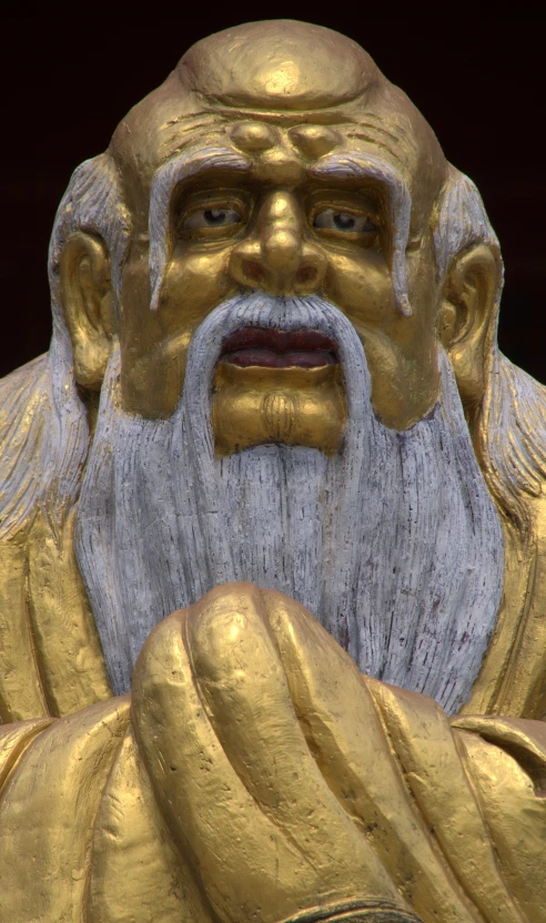 an asian man statue is looking to his right