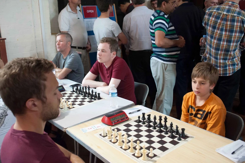 a group of people playing a game of chess