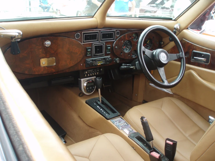 an interior s of a brown car with dashboard and steering wheel