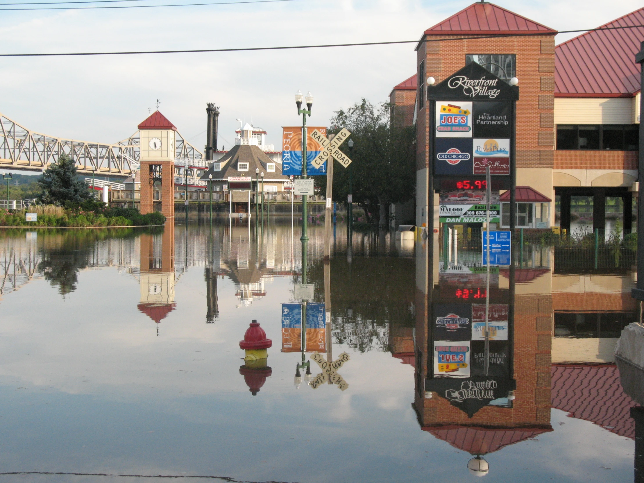 water reflecting buildings and traffic signs in a flooded street