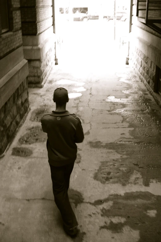 a young man walking down an empty street