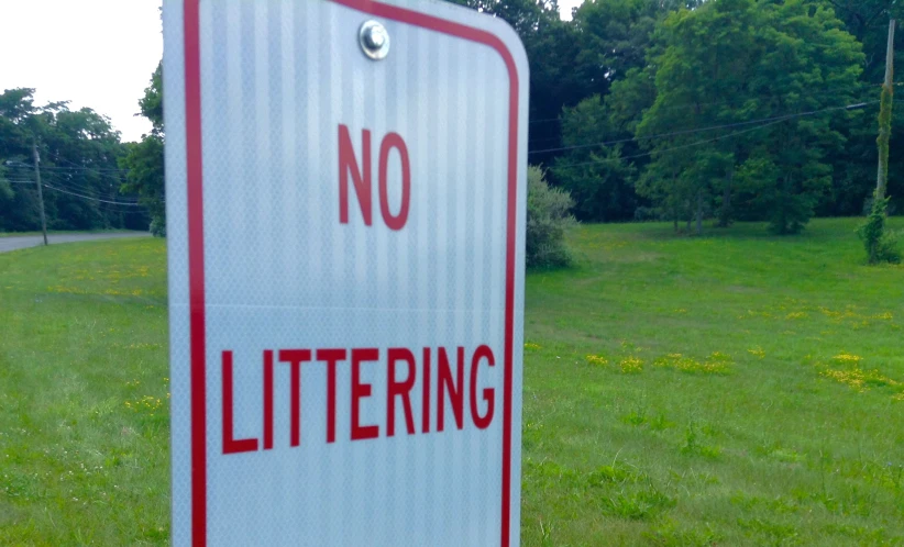 a red and white sign on the side of a road