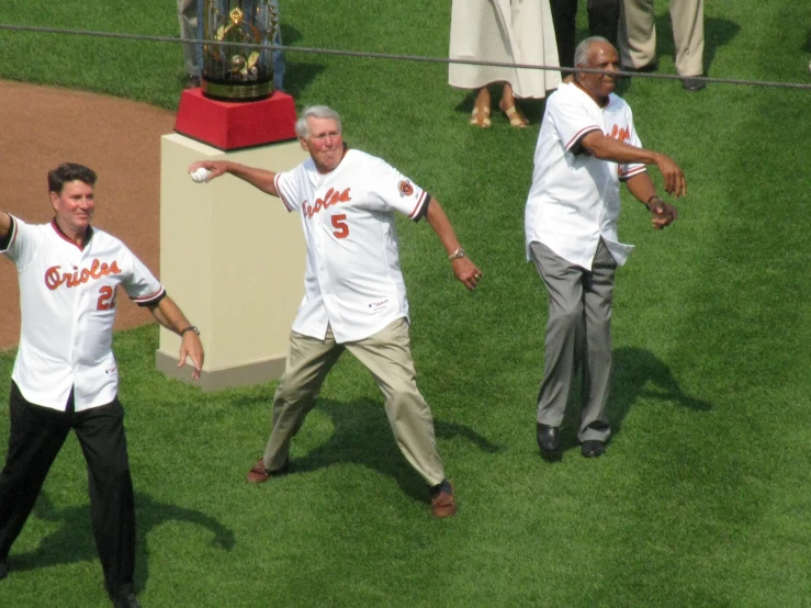 baseball players on the field and the man is pointing