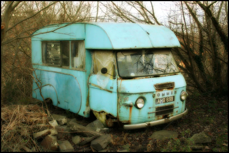 an old and broken down blue and white bus