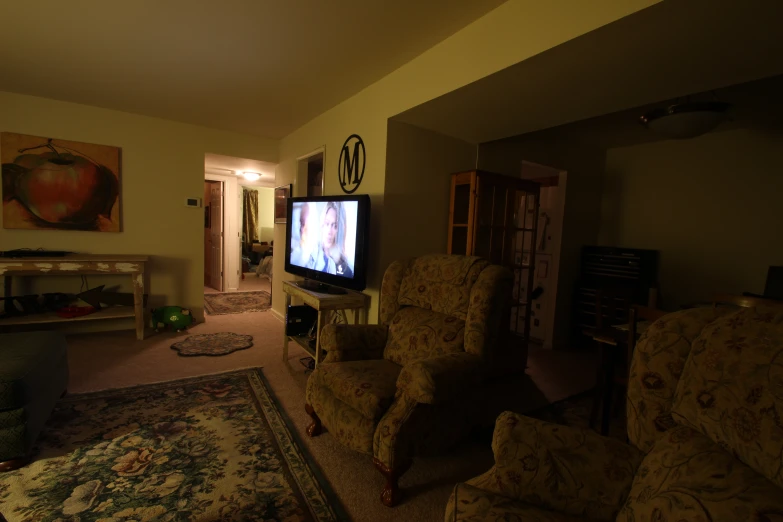 a tv sitting on top of a wooden cabinet in a living room