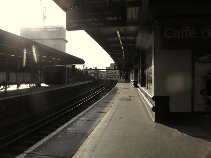 a train station with trains on the tracks