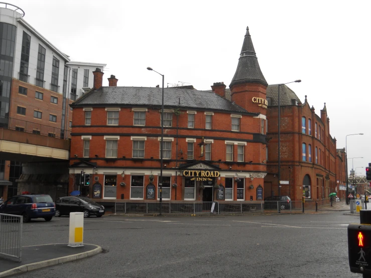 a large brick building on the corner of a street