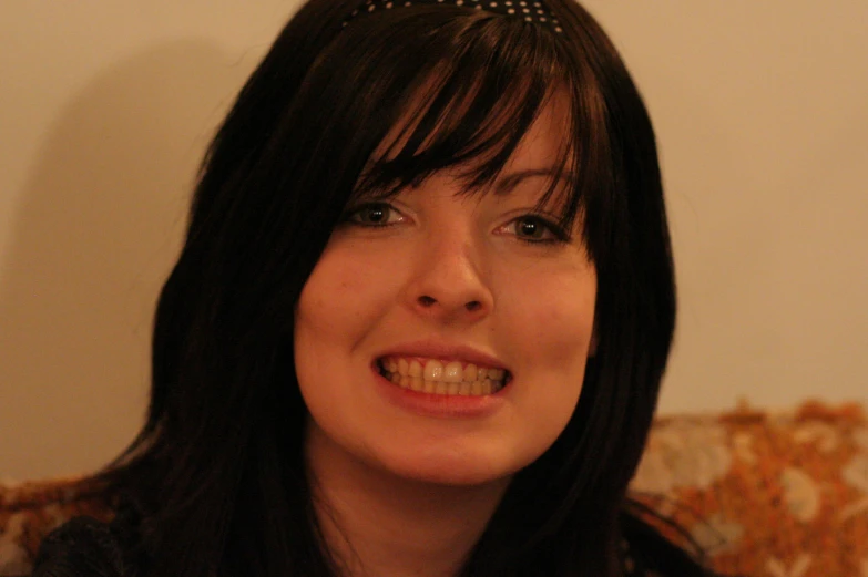 a woman with black hair is smiling