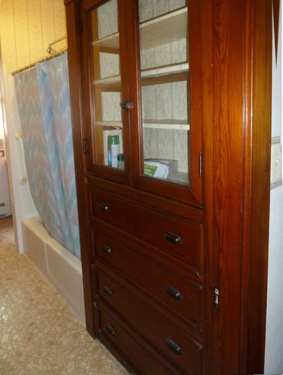 a bathroom with a medicine cabinet with three doors