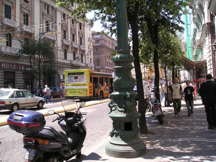 a green street lamp sits on the side of a street