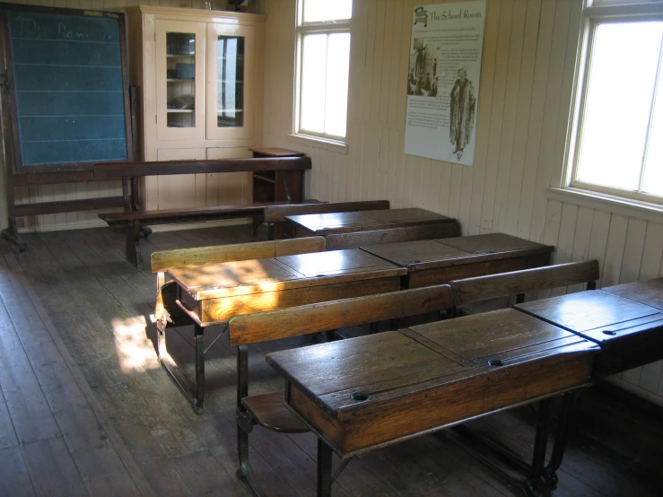 a row of desks in an old school classroom