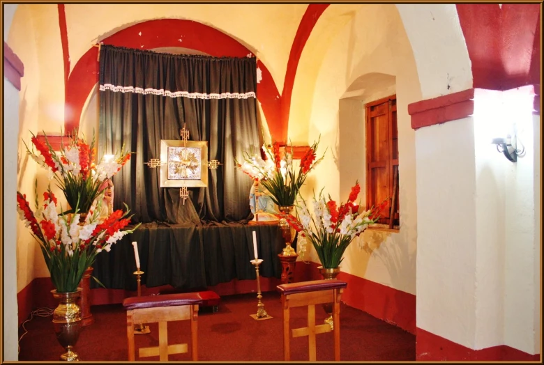 a set of three small altars with flowers on the front and back