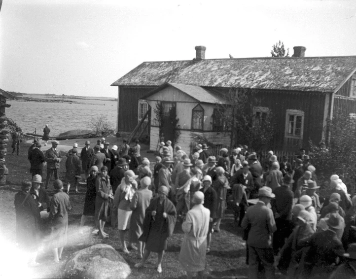 a group of people are gathered outside a house
